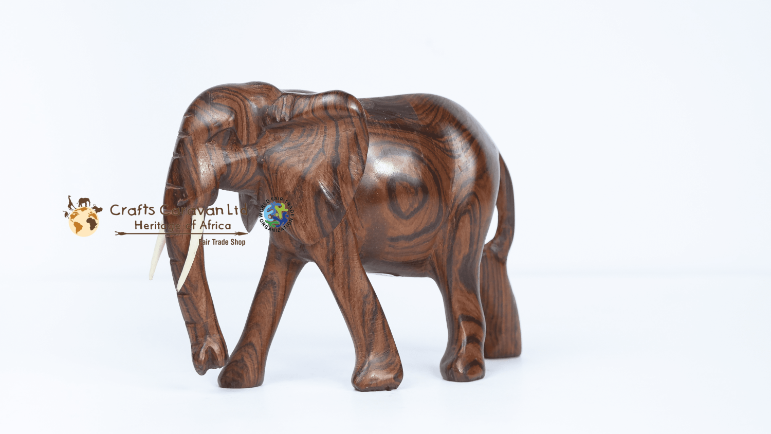 Wooden elephant with trunk down